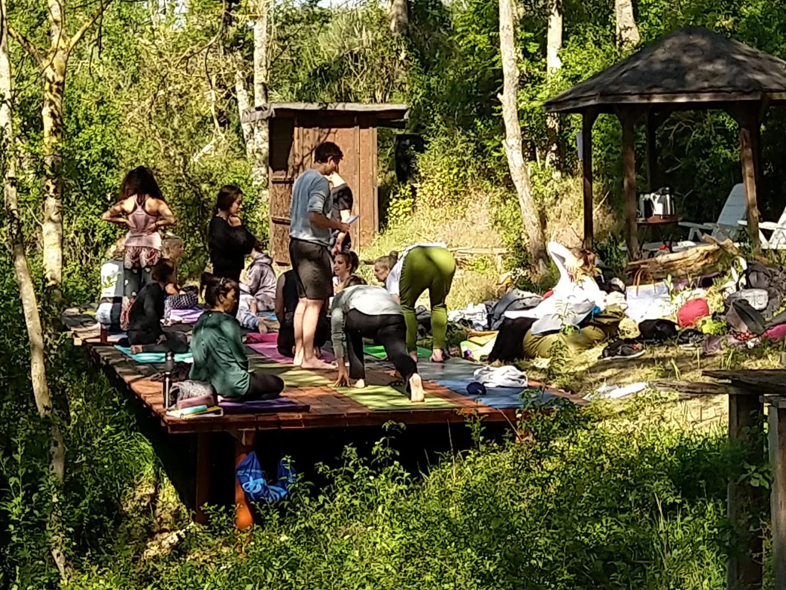 a group of people sitting on mats with hands together